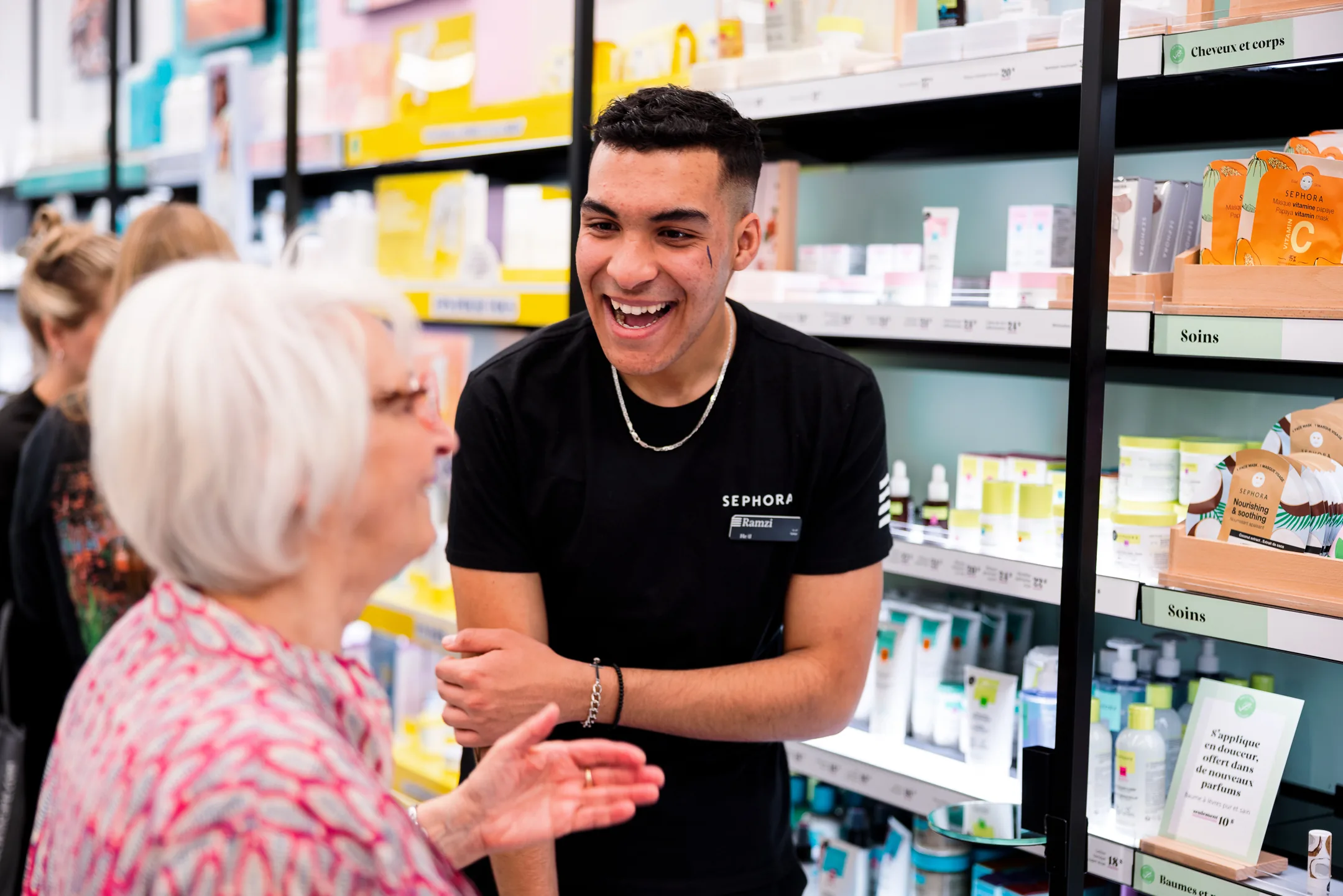 Sephora Canada — an advisor laughing with a client at the skincare wall