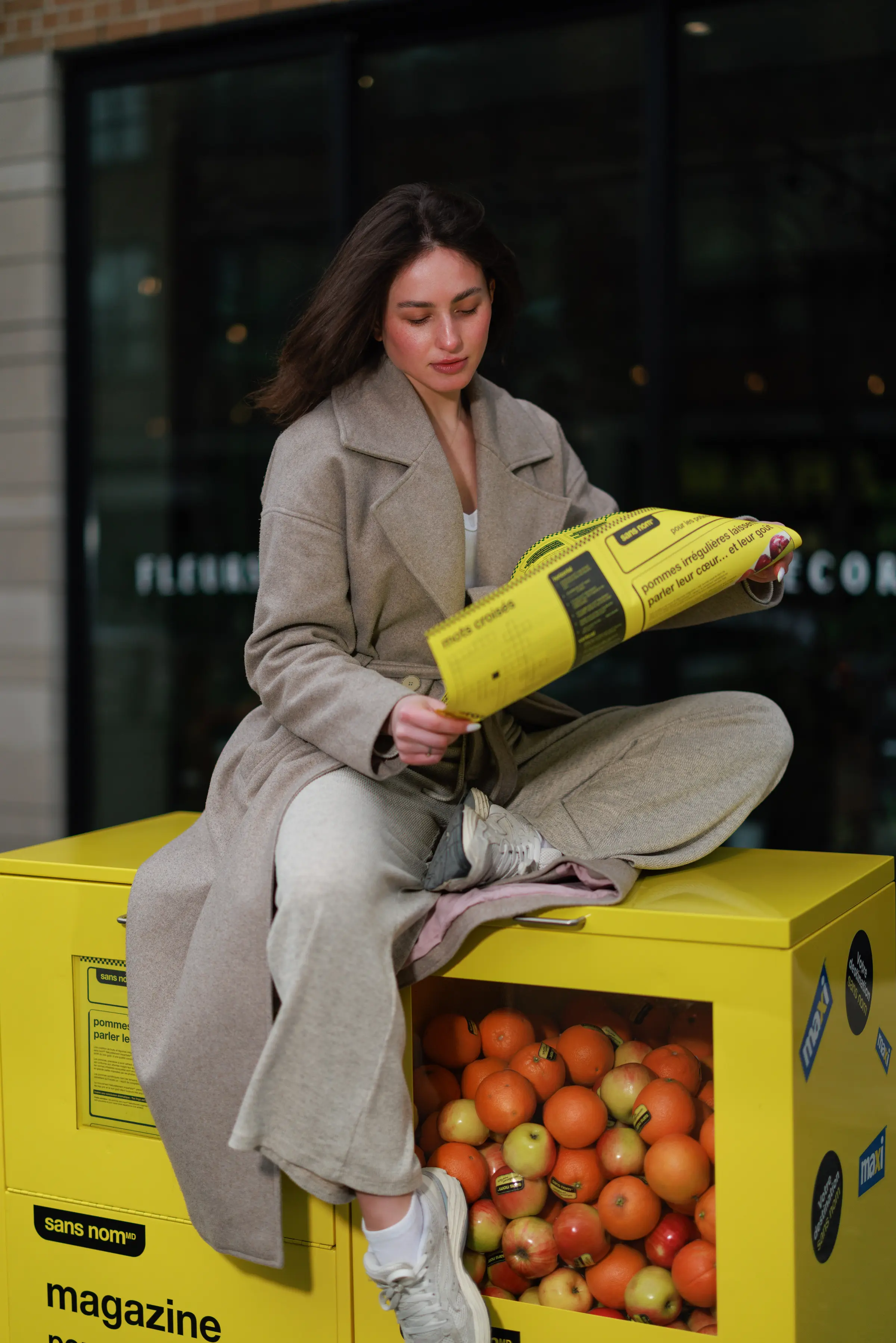 No Name — No Name — model reading the sans nom tabloid on the box